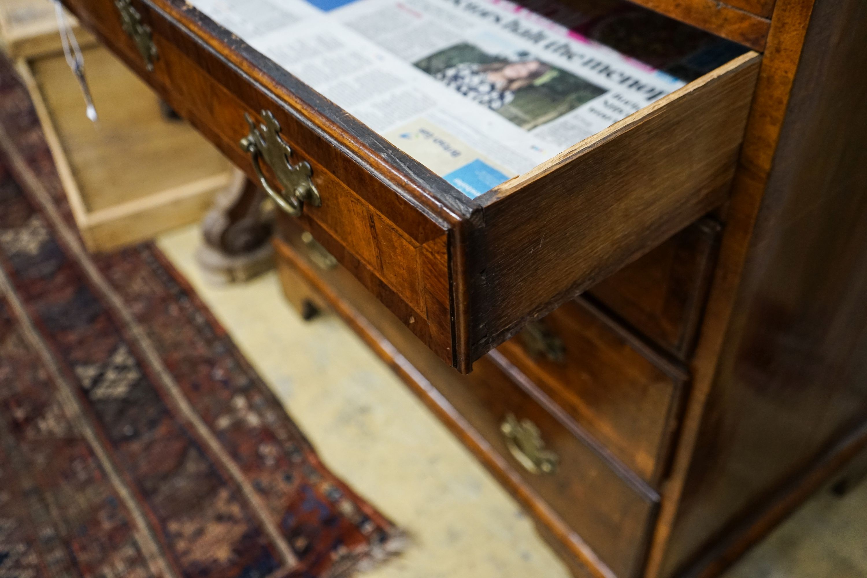 An 18th century and later feather banded walnut chest with slide, width 84cm, depth 49cm, height 86cm